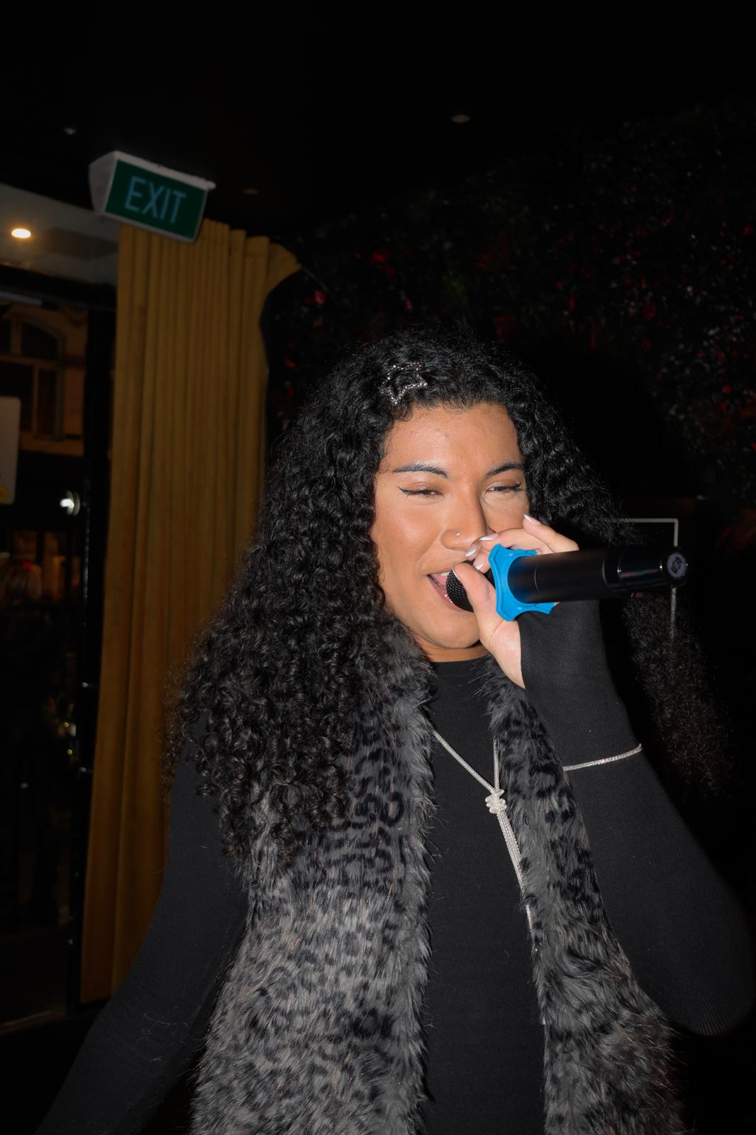 A guest singing karaoke at Illumina